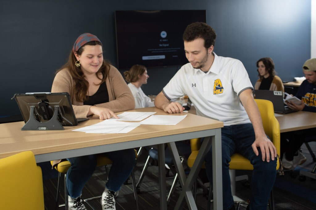 This is an image of a student working with one of the advisors on a project she is working on. 